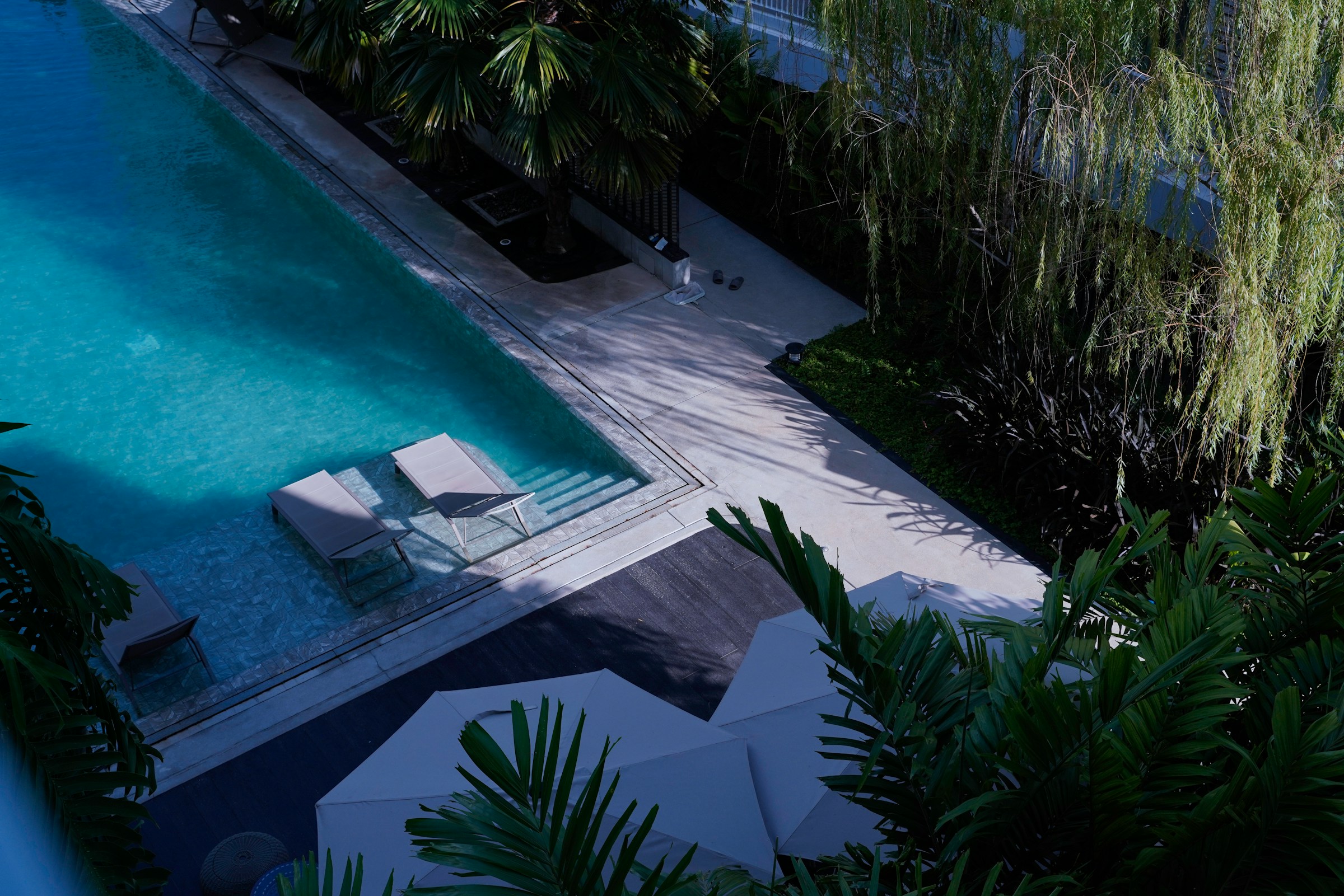 Aerial view of a finished residential pool at dusk