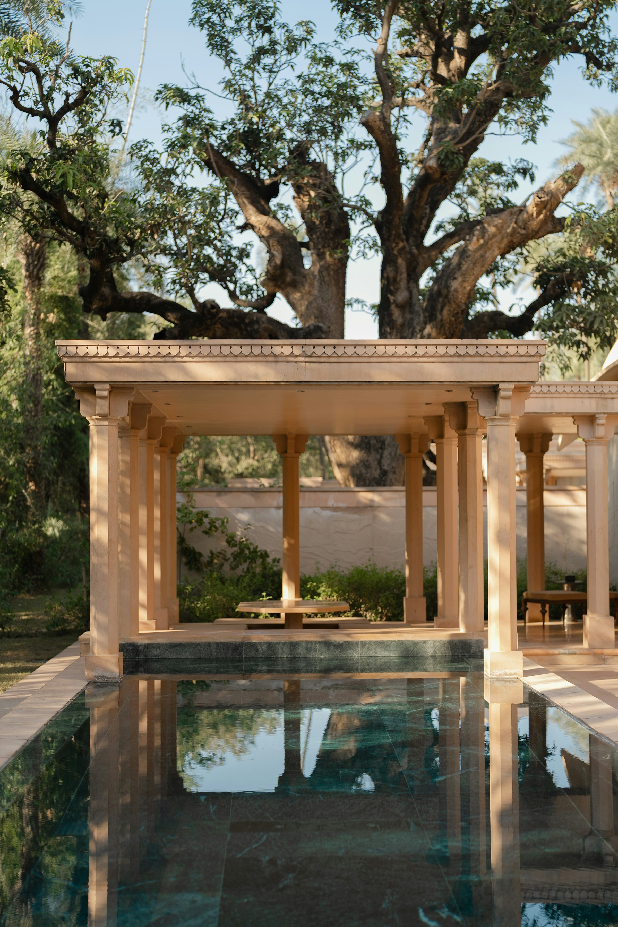 Sandstone pergola reflecting in still water