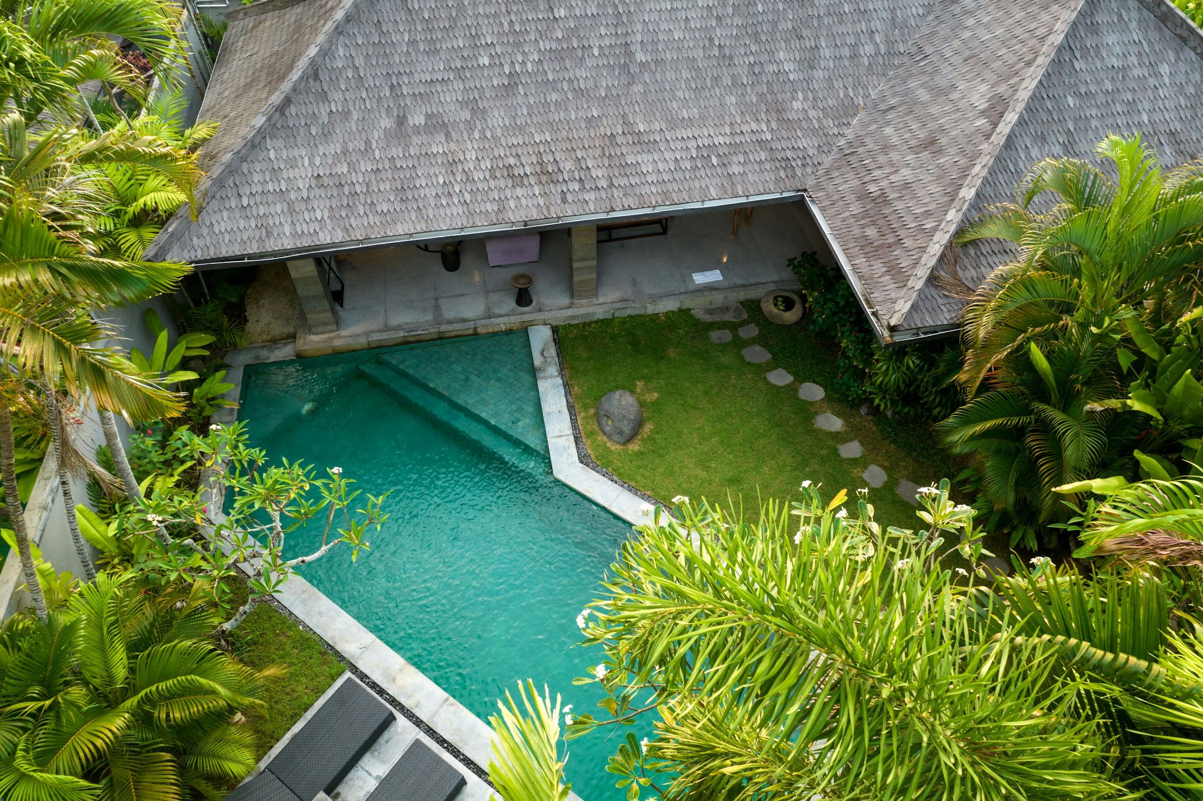 Aerial view of shingle-roofed residence and pool