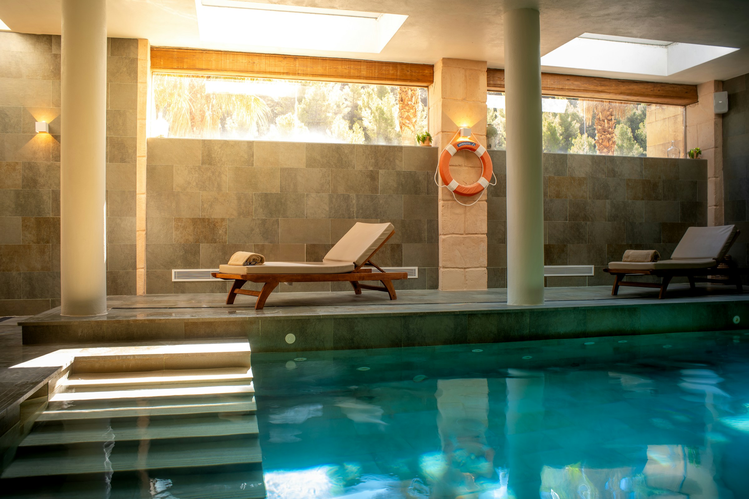 Sunlit indoor pool skylight lounge